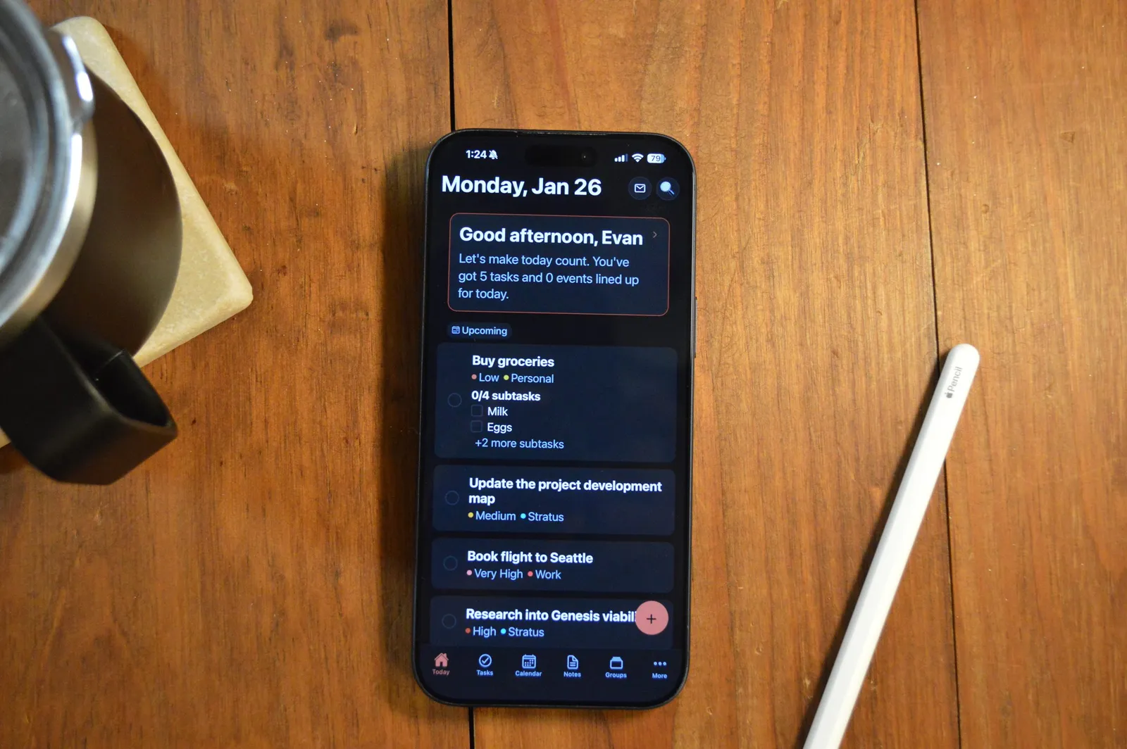 Atlas on a phone next to a notebook and pencil