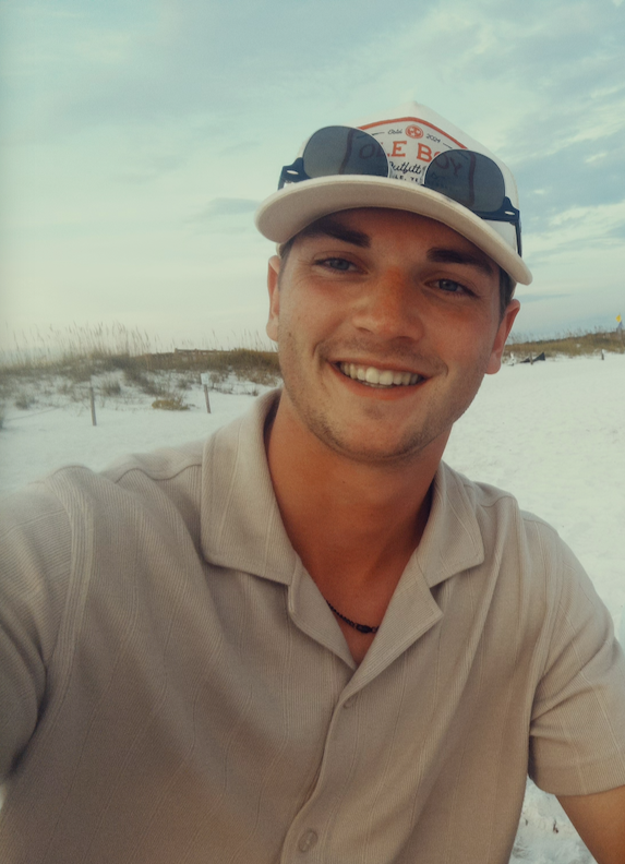 Evan Bradley smiling at the beach